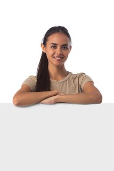 Portrait casual hispanic woman displaying a banner ad isolated over a white background