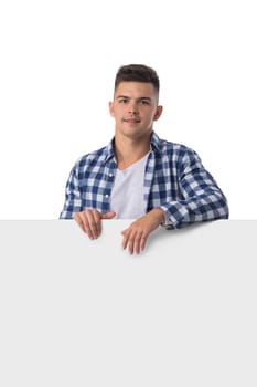 Portrait of happy smiling casual man holds blank board isolated on white background