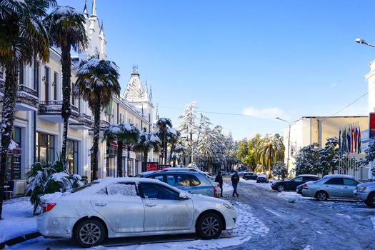 Sukhumi, Abkhazia-January 29, 2017: Urban street of the capital of Abkhazia with beautiful buildings, cars and people in a snowy winter day.