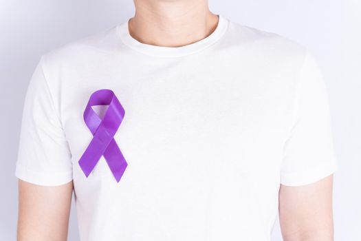 World cancer day, purple ribbon on chest isolated grey background. Healthcare and medical concept.