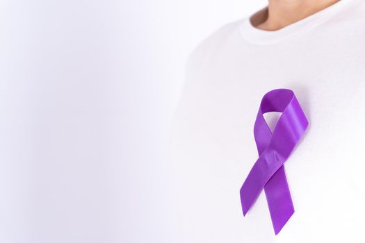 World cancer day, purple ribbon on chest isolated grey background. Healthcare and medical concept.