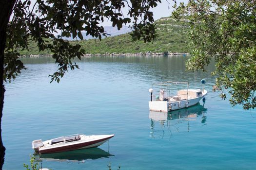 Two boats in calm waters of Mediterranean Adriatic sea in Croatia