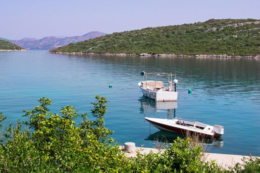 Two small fishing boats in calm waters of Adriatic sea in Croatia