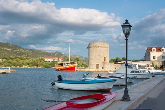 Small fishing boats in Mediterranean Adriatic sea bay tied to town quay