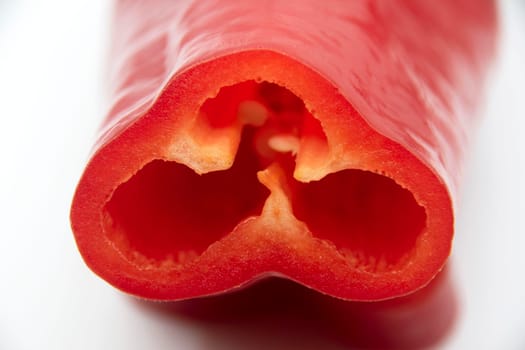 Ripe juicy capi of sweet pepper in a cut on a white background.