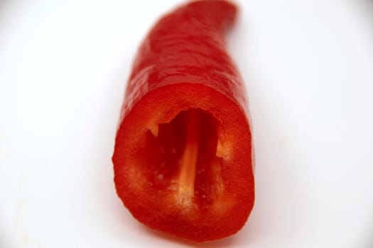 Ripe juicy capi of sweet pepper in a cut on a white background.