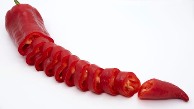 Ripe juicy capi of sweet pepper in a cut on a white background.