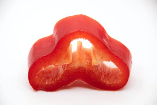 Ripe juicy capi of sweet pepper in a cut on a white background.