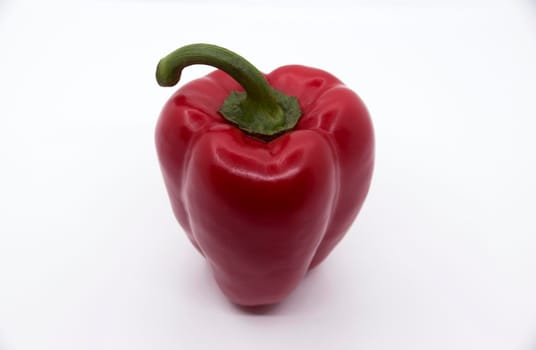 Ripe juicy sweet bell pepper on a white background.