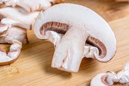 Close-up of a slice of edible mushroom Royal champignons on a cutting board. Delicious and healthy food concept.