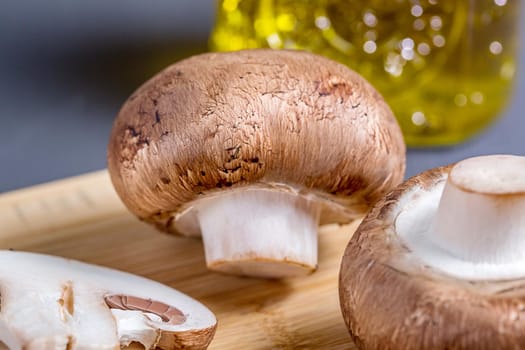 Close-up of edible mushroom Royal champignons, Parisian champignons, on a cutting board. Organic food preparation concept.