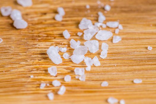 Coarse sea salt for cooking on cutting board, cooking background high angle view