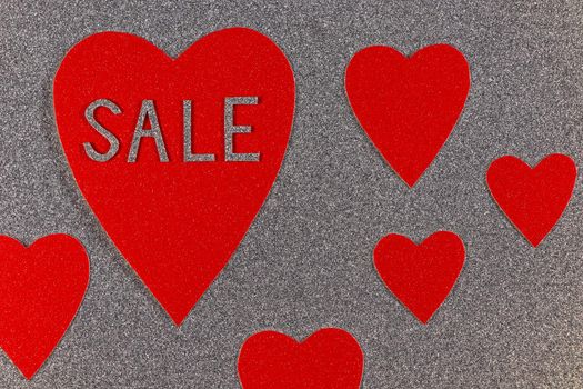 Saint Valentine's day red heart sale love theme with red hearts on silver