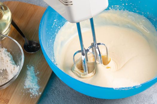 Kneading baking dough with an electric mixer.