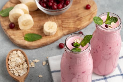 Homemade yogurt smoothie with banana, cranberry and oatmeal.