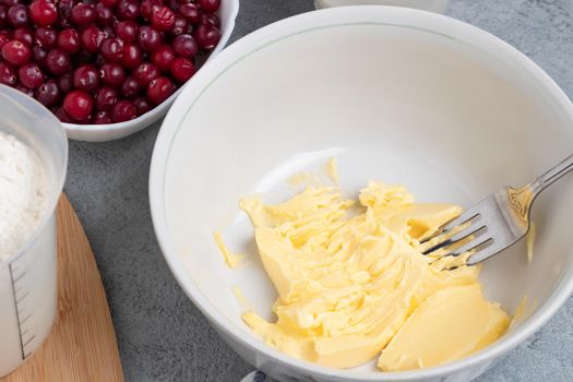 Making a dough for a sweet cranberry pie. Melted butter in a bowl.