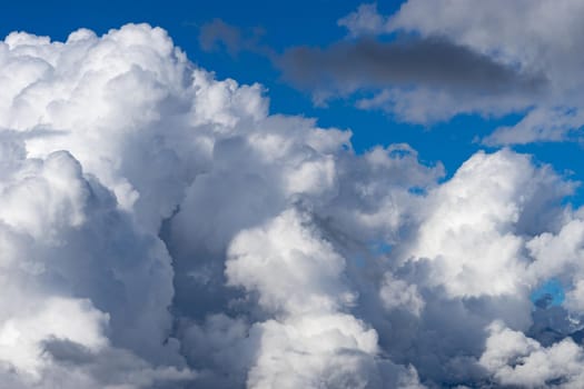 White fluffy clouds on the tops of mountains.