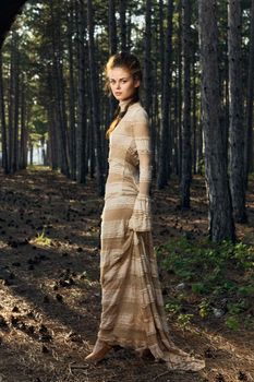 woman in the forest fresh air dress trees pine cones nature. High quality photo