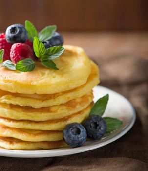 Stack of pancakes with fresh berries, close-up