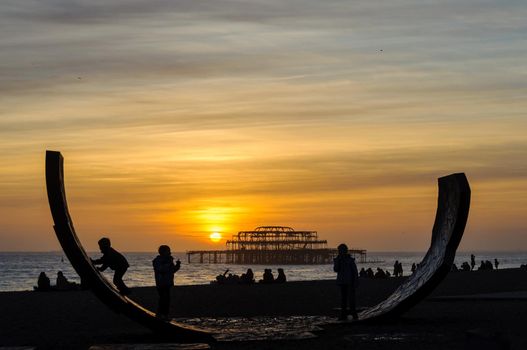 BRIGHTON, UK - CIRCA FEBRUARY 2011: Passacaglia sculpture by Charles Hadcock and the West Pier at sunset in Brighton, England, UK.