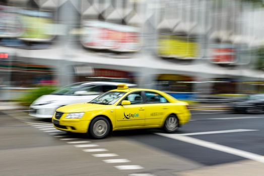 SINGAPORE - CIRCA JANUARY 2016: Yellow Hyundai taxi with motion blur.