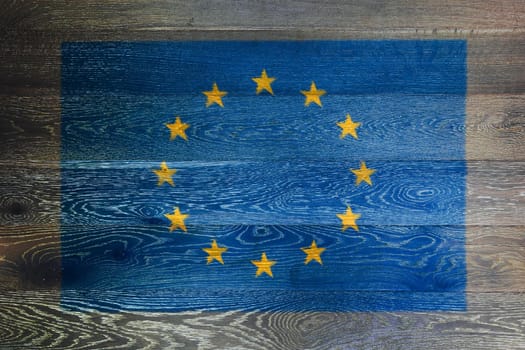 A European union flag on rustic old wood surface background
