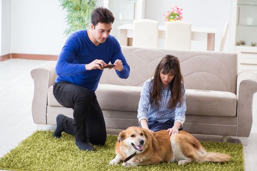 Happy family with golden retriever dog