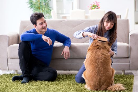 Happy family with golden retriever dog