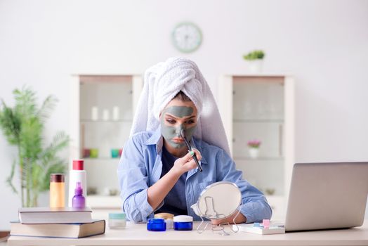 Beauty blogger applying mask and posting to internet blog