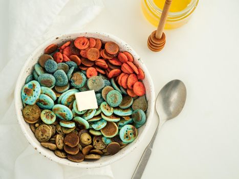 Trendy food - pancake cereal. Heap of colorful mini cereal pancakes. Tiny pancakes with natural color - green matcha, turquose spirulina, blue pea, red fragon fruit
