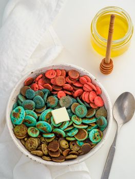 Trendy food - pancake cereal. Heap of colorful mini cereal pancakes. Tiny pancakes with natural color - green matcha, turquose spirulina, blue pea, red fragon fruit