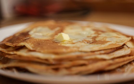 Lots of hot pancakes on the plate.