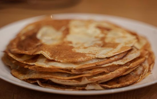 Lots of hot pancakes on the plate.