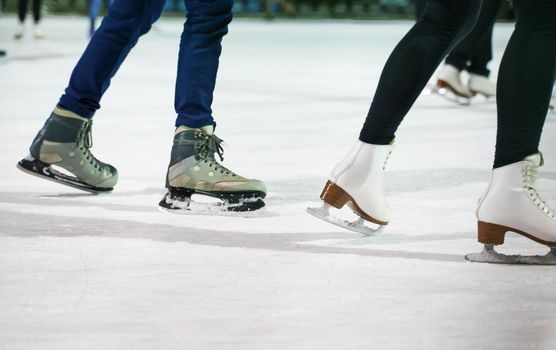 People ice skating on the ice rink in winter.