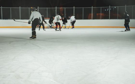 People play hockey outdoors in winter time.