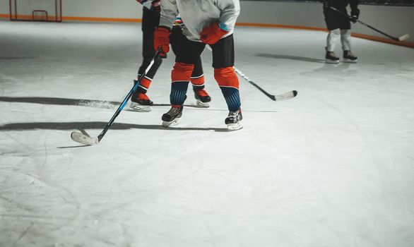 People play hockey outdoors in winter time.