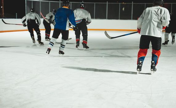 People play hockey outdoors in winter time.