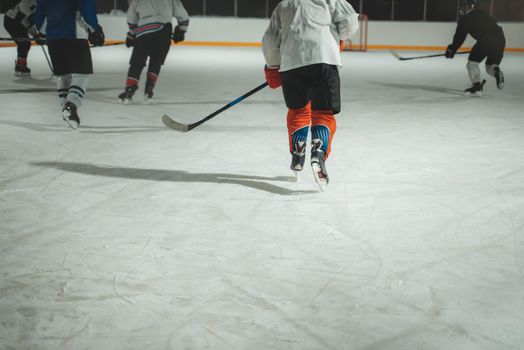 People play hockey outdoors in winter time.