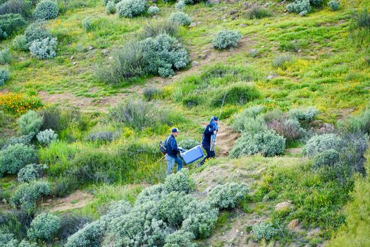 Two fisher-mans walking in the valley to the lake. Diamond Valley Lake. One of the largest reservoirs in Southern California. USA. January 16th, 2021