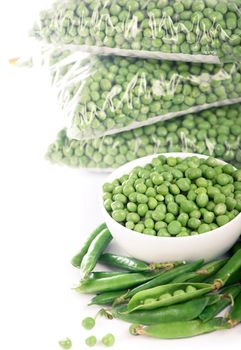 Composition with organic frozen vegetables on white background. Green peas in the package