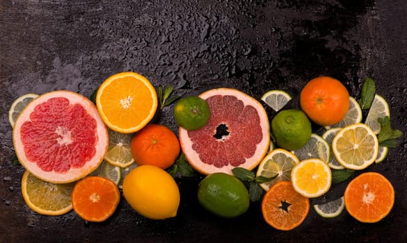 Citrus background. Fresh citrus fruits - Lemons, oranges, limes, grapefruits On wooden background