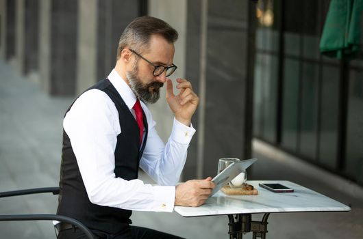 Business people talking in office using digital tablet and social media technology for communication.