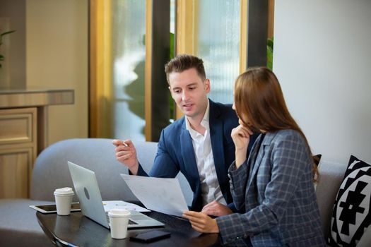 Business people talking in office using digital tablet and computer 