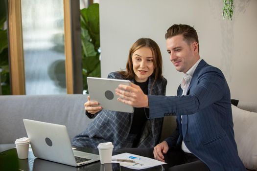 Business people talking in office using digital tablet and computer 