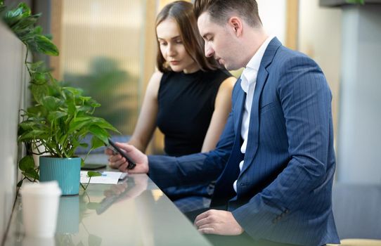 Business people talking in office using digital tablet and computer 