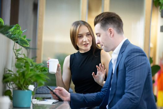 Business people talking in office using digital tablet and computer 