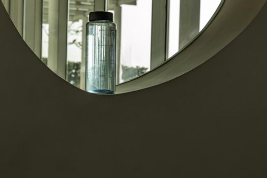 Sport water bottle in sport club or gym and fitness room with free space. Gym concept. Selective focus.