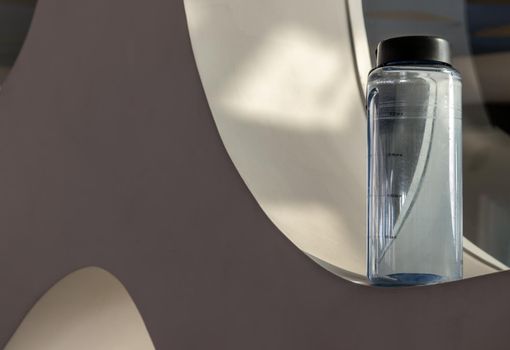 Sport water bottle in sport club or gym and fitness room with free space. Gym concept. Selective focus.
