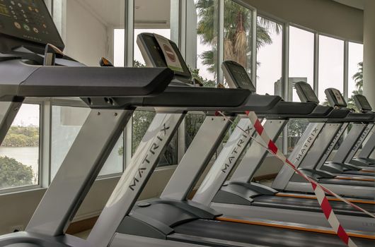 Bangkok, Thailand - 24 Jan 2021 : New normal concept and physical distancing people running in fitness and keep spaced to prevent from disease outbreak. New normal after COVID-19 pandemic concept. Social distance concept. Selective focus.