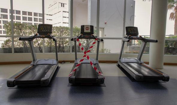 Bangkok, Thailand - 24 Jan 2021 : New normal concept and physical distancing people running in fitness and keep spaced to prevent from disease outbreak. New normal after COVID-19 pandemic concept. Social distance concept. Selective focus.